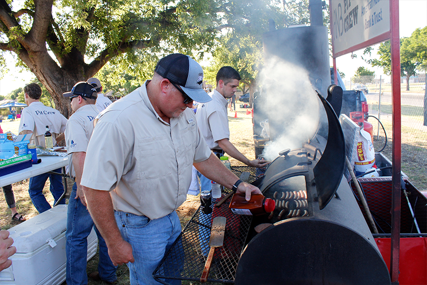 Employees cooking food for a cookout