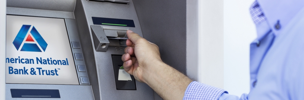 Atm man putting card into atm