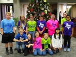 Group of students smiling in front of Christmas Tree from Fowler Elementary.