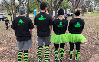 Bryan Hines, Curt Knobloch, Alisha Bowers, and Meagan Swenson showing backside of Thor AMNAT shirts.