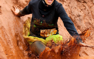 Meagan Swenson sliding into a mud pit.